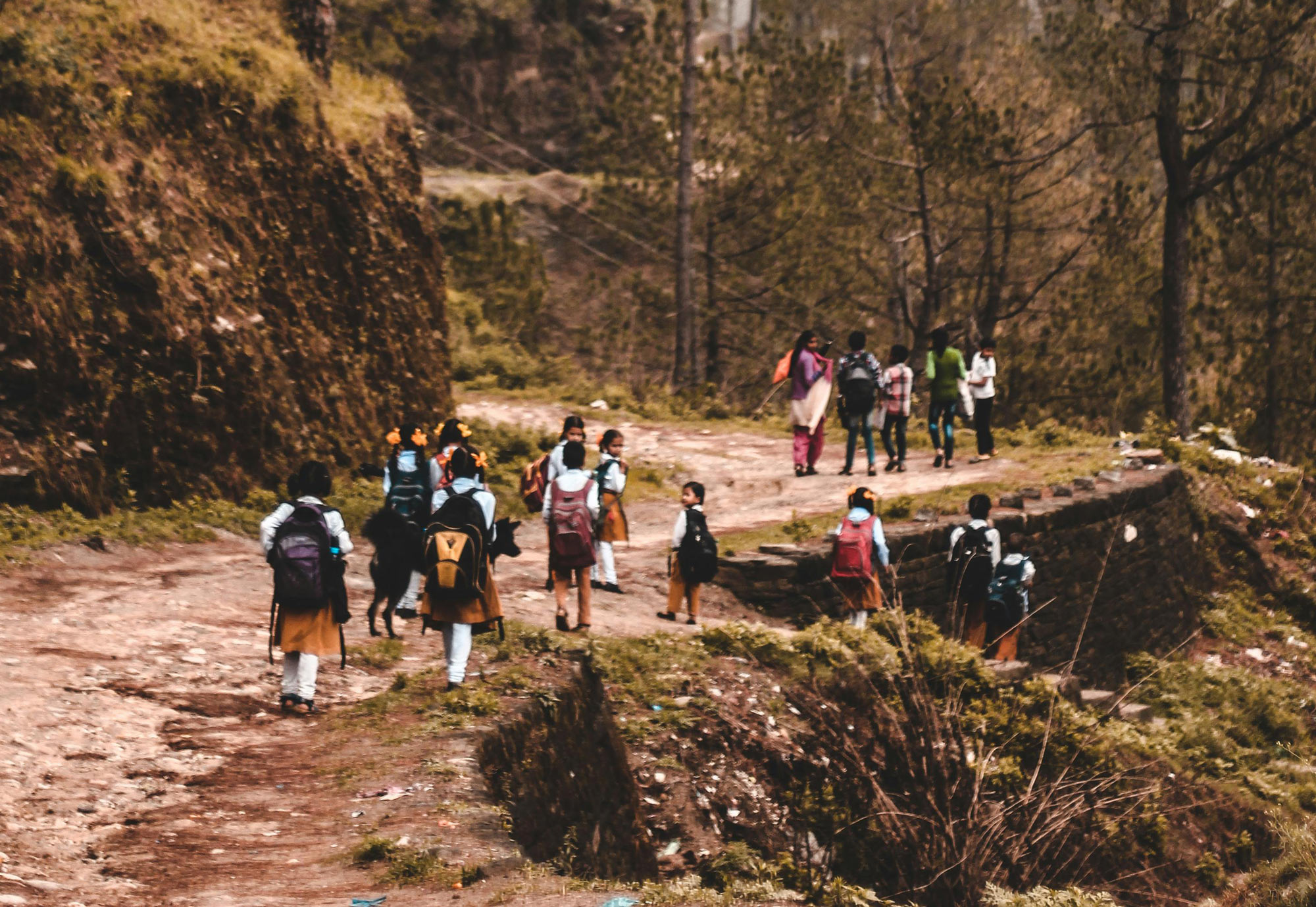 Photo of African students walking to class with uniforms and backpacks